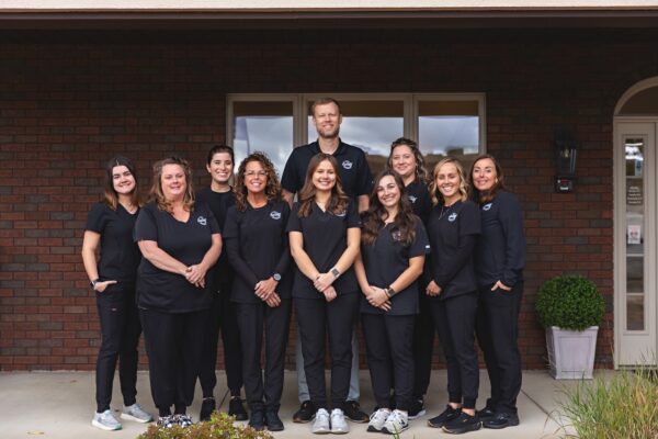 Dr Springer and his staff members in a group photo outside of their office
